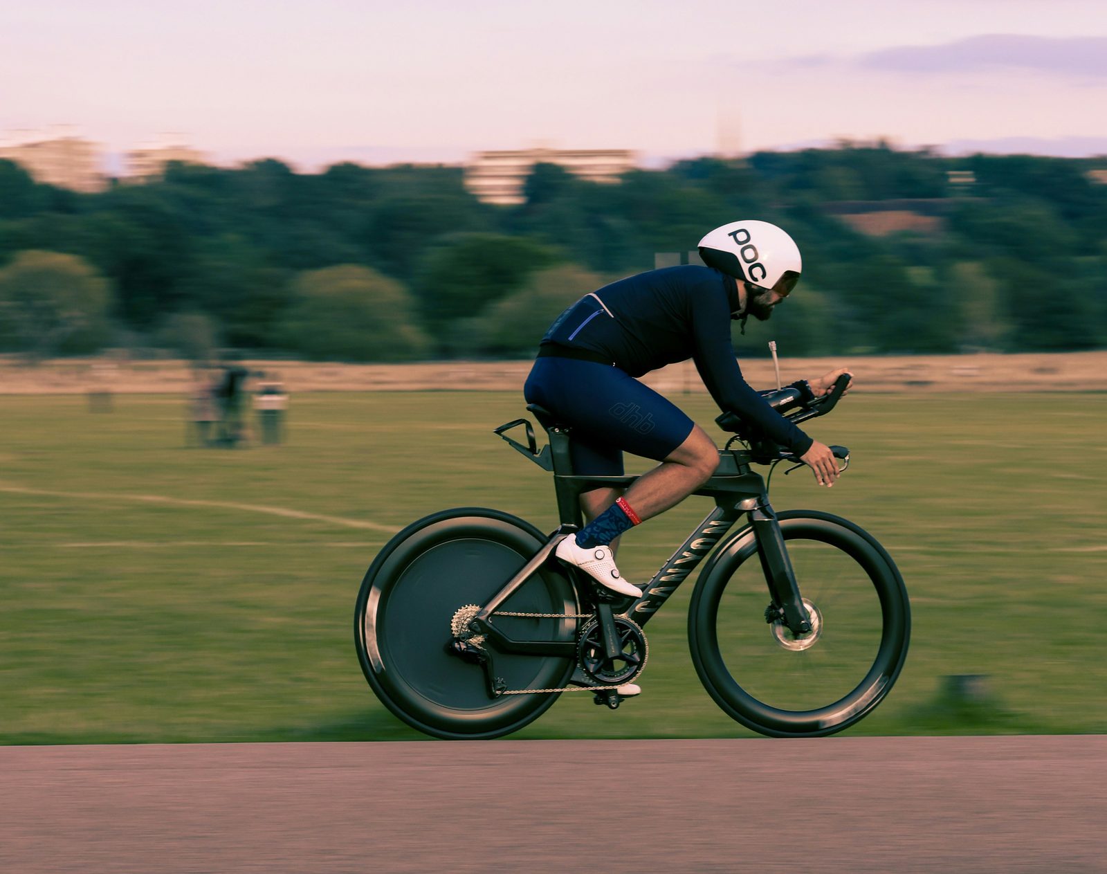 A triathlete in an aero tuck on a TT bike